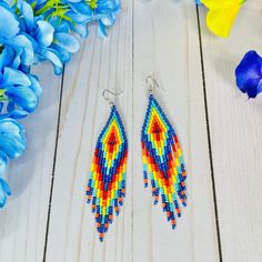 These colorful beaded earrings are sure to add a cute pop of color to any boho chic look or summer outfit. Part of our Desert Sunset Collection, these bohemian fringe earrings feature beautiful colors to wear all year long (navy blue, yellow, orange and turquoise). With an Exclusive Colorful 4U design, these seed bead earrings in boho chic style are part of the traditional Emberra art and culture, combining stylish designs with ancient tribal patterns and craftsmanship.  Details: Lightweight lon Bohemian Orange Earrings, Orange Tiny Beaded Earrings For Festival, Orange Tiny Beads Earrings For Festival, Summer Festival Orange Earrings, Orange Beaded Drop Earrings For Festival, Bohemian Orange Tassel Earrings For Festivals, Colorful Ear Wire Earrings For Beach, Summer Dangling Bead Teardrop Earrings, Multicolor Bohemian Beaded Earrings As Gift