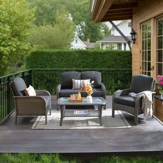 a patio with furniture and flowers on the table