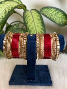 red    Bangles with Kundan Detailing. These stylish bangles are made from copper and feature Kundan  stones.  Features: - Made from copper  - red   - Artificial  Kundan detailing  - Available in size 2.6,2.8,2.10 Red Hand Set Bangle For Festivals, Red Bangles Set Bridal, Hand Set Red Bangle For Festivals, Traditional Red Bracelet With Stone Work, Traditional Red Stone Work Bracelet, Red Ruby Bangle As Gift, Festive Red Metal Jewelry, Red Stone Work Bangle Jewelry, Hand Set Red Bangle For Celebration