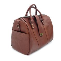 Elevate your carry-on with our newest bag the Travel Duffle. A bag that gets you anywhere you need to go, from the conference room to a weekend retreat, packing everything you need in style. Handcrafted in full-grain leather with antique brass hardware and storage compartments both inside and out. Complete with zipper closure, top strap buckle accent, smooth and sturdy handles, and removable crossbody strap. Details Double top handles Adjustable 54" crossbody strap Zipper and front clasp closure Elegant Travel Satchel With Brass Hardware, Classic Large Capacity Leather Backpack For Travel, Classic Leather Satchel For Travel, Luxury Brown Satchel With Brass Hardware, Luxury Cognac Bag With Brass Hardware, Classic Satchel Travel Bag For Trips, Classic Travel Accessories With Leather Handles For Daily Use, Classic Leather Weekender Bag For Trips, Cognac Leather Weekender Bag For Travel