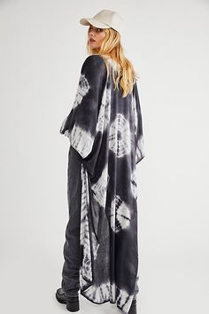 In a super soft fabric and tie dye pattern this oversized maxi kimono features statement cutout detailing under the arms. Chic Flowy Kimono For Beach Cover-up, Black Bohemian Maxi Length Kimono, Flowy Unlined Beachwear Cover-up, Oversized Wrap Kaftan For Beach Cover-up, Oversized Maxi Cover-up For Beach Season, Bohemian Flowy Unlined Cover-up, Flowy Bohemian Wrap Maxi Dress, Oversized Black Bohemian Cover-up, Flowy Bohemian Unlined Cover-up