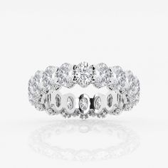 a white gold and diamond ring with three rows of diamonds on the band, set in 18k white gold