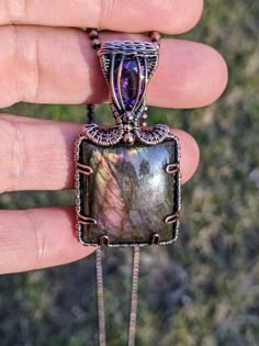 This is a gorgeous wire wrapped pendant and one of my personal favorites!!  This pendant features a square Labradorite cabochon and an Amethyst carefully wrapped in copper wire.  This pendant measures 2 inches tall, 1 inch wide, and comes on a 24" copper ball chain.  This piece  has been oxidized and polished to give it a darkened "antiqued" finish. Copper will naturally continue to oxidize (darken) over time and will need polishing to keep it looking gorgeous. This piece is so beautiful and unique, it will make an amazing addition to any jewelry collection.  This item comes packaged in a gift box and ships via USPS priority mail with tracking number and insurance. Luxury Wire Wrapped Teardrop Jewelry, Wire Wrapped Square Stone, Wire Wrapped Stone Jewelry, Wire Wrap Jewelry Designs, Wire Wrapped Jewelry Diy, Copper Wire Jewelry, Copper Jewelry Handmade, Wire Wrapping Stones, Necklace Patterns