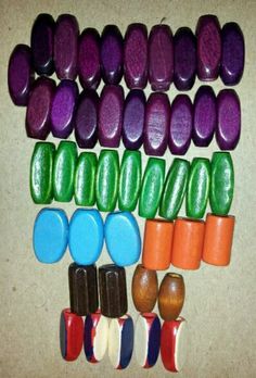 there are many different colored candys on the table together and one is purple, green, orange, and white