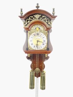 an antique clock with bells and chains hanging from it's sides on a white background