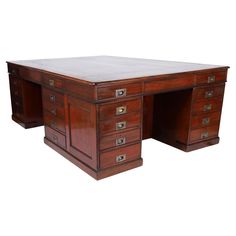 an antique wooden desk with drawers and marble top