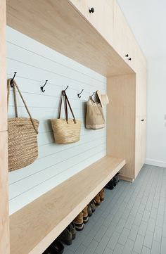 the shoes are lined up against the wall and hanging on the hooks in the shoe rack