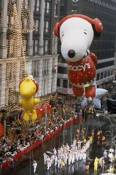 the macy's christmas parade float is being followed by snoopy and winnie the pooh