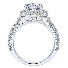 a white gold engagement ring with an intricate halo setting