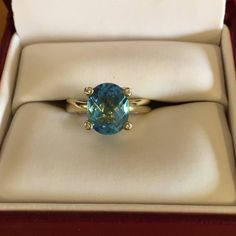 Ladies 10kt Yellow Gold Swiss Blue Topaz And Diamond Ring. Four Small Diamonds Are Set In The Prongs. Blue Swiss Topaz Is A Oval Checkerboard Cut 8 X10. Ring Size Is 5 1/4. Used But In New Condition. Diamond Cut Round Topaz Ring, Yellow Gold Diamond Cut Blue Topaz Ring, Oval Blue Topaz Ring With Diamond Cut, Fine Jewelry Yellow Gold Topaz Gemstones, Yellow Gold Blue Topaz Ring With Center Stone, Diamond Cut Topaz Ring, Yellow Gold Topaz Ring With Center Stone, Heirloom Blue Topaz Ring With Diamond Cut, Round Diamond Cut Topaz Ring