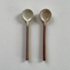 two wooden spoons sitting next to each other