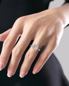 a woman's hand with a diamond ring on it