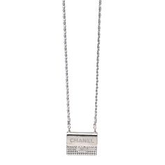 This is an authentic CHANEL Metal Lambskin Strass Crystal Purse CC Long Necklace in Silver. This mini silver crystal purse features a long sliver chain link metallic leather strap and crystal-set Chanel CC logos. Chanel Long Necklace, Elegant Metal Necklace With Silver-tone Logo, Silver Necklace With Silver-tone Logo Plaque, Elegant Silver Necklaces With Silver-tone Logo Plaque, Elegant Silver Necklace With Silver-tone Logo Plaque, Luxury Silver Necklaces With Silver-tone Logo, Luxury Silver Necklaces With Logo Plaque, Luxury Silver Jewelry With Chain Strap, Luxury Silver Necklace With Rhinestones