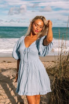 - Become a style muse with this gorgeous dress! - Fully lined material - A v-cut neckline with a tie detail - Short, loose sleeves with elastic shoulders and elastic cuffs - A smocked bodice - A figure flattering silhouette that ends in a ruffled hemline Measurements S : Bust 32", Hip 36", Length 32", Sleeve Length 13.5", Waist 26-30". M : Bust 34", Hip 38", Length 33", Sleeve Length 14", Waist 28-32". L : Bust 36", Hip 40", Length 33.5", Sleeve Length 14", Waist 30-34". Baby Blue Sundress, Smocked Mini Dress, Trendy Bikinis, Style Muse, Loose Sleeves, Tropical Vibes, V Cuts, Summer Holiday, Tropical Print