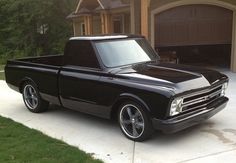 a black truck parked in front of a house