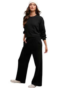 Elevate your loungewear game with our Knit Sweat Top and Wide Leg Pants Athleisure Lounge Set. The cozy knit sweat top features a classic round neck and long sleeves for a relaxed fit, while the wide-leg long pants offer comfort and style. The elastic waist ensures a customizable fit, and the inclusion of pockets on the pants adds a practical touch to the ensemble. - Model is 5' 10" 32-26-35 and wearing a size MediumMeasurement from a Small:Pants Inseam: 27"Top Length: 19.5"import Style: Casual Fall Long Sleeve Sweats With Elastic Waistband, Relaxed Sweats For Loungewear, Relaxed Solid Color Sweats For Loungewear, Solid Color Relaxed Sweats For Loungewear, Relaxed Fit Sweatpants For Fall Loungewear, Fall Relaxed Fit Sweatpants For Loungewear, Fall Loungewear Relaxed Fit Sweatpants, Comfy Sweats For Fall Loungewear, Oversized Sweatpants For Fall Lounging