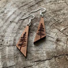 wooden earrings with trees engraved on them