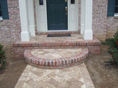 a brick house with steps leading to the front door