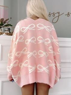 Cozy up in style with our Bow My Way Cardigan from Sassy Shortcake. This oversized cardigan features a playful pink hue and a charming bow detail, making it the perfect addition to any outfit. Stay warm and on-trend with this must-have piece. fit: oversized (model wearing a size small) content: 60% acrylic 20% chinlon 20% polyester care: hand wash cold Chic Oversized Pink Sweater, Long Sleeve Sweater With Bow For Spring, Oversized Trendy Pink Cardigan, Spring Long Sleeve Sweater With Bow, Winter Pink Soft Knit Cardigan, Oversized Cozy Pink Cardigan, Cozy Pink Winter Cardigan, Pink Cute Sweater For Loungewear, Cute Pink Sweater For Loungewear