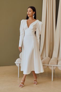 Fabric: Heavy Satin Cotton 50%, Polyester 50% V-neck dress Puffed sleeves Long sleeves Bow on back detail Zipper on back Dress lenght: 125 cm/ 49,2 inSleeve length: 68 cm/ 26,7 in Colors: White, Sky-Blue, Dusty Pink Fitted V-neck Puff Sleeve Dress For Wedding, Chic V-neck Long Sleeve Dress With Gathered Sleeves, V-neck Dress With Gathered Sleeves For Work, Elegant V-neck Midi Dress With Elastic Sleeves, Elegant Fitted V-neck Dress With Gathered Sleeves, V-neck Midi Dress For Fall Wedding, Fall Wedding V-neck Midi Dress, Fitted Lantern Sleeve Dresses For Work, Long Sleeve Ruched Midi Dress With Fitted Bodice