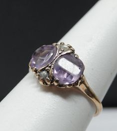 certainly one of the prettiest antiques i have seen. 2 panel cut amethyst , and very pale lavender for amethyst. Both are perfectly matched and about 1ct each. Has an accent seed pearl at the top and bottom. Petite ring , 11mm's north-south. This has been sized and the markings are lost. Tests 14K and in remarkable antique condition. 1.53 dwt. Antique Purple Amethyst Ring With Accent Stones, Vintage Purple Amethyst Ring For Anniversary, Vintage 14k Gold Amethyst Ring With Accent Stones, Purple Amethyst Ring Stamped 14k, Vintage Yellow Gold Amethyst Ring, Victorian Style Oval Purple Amethyst Ring, Purple Amethyst Ring With Rose Cut Diamonds For Wedding, Vintage Purple Amethyst Ring For Wedding, Victorian Style Purple Oval Amethyst Ring