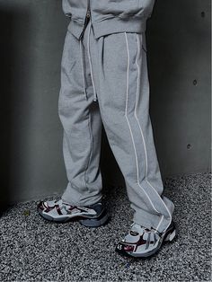 Editor's NotesThis voluminous sweatpants is designed with reflective 3M piping along the side panels and adjustable drawcord and stopper at the hem that allow creating versatile silhouette. It's topped with comfortable banding waist to fits easily for unisex. - Elasticated drawstring waistband- Two front on-seam pockets- Two back patch pockets- Front tucks- Side panel with 3M reflective piping- Adjustable drawcord at the hem- Wide balloon fit- Unisex wearMeasurements (in.) One size- Waist: 14.2 in. - Thigh: 14.2 in. - Rise: 14.2 in.- Hem: 9.4 in.  - Total Length: 42.5 in.Model Info: 5' 10.9/ Fitting size Top one size, Bottom one sizeComposition & Care- Cotton- Refer to the care labelDesigner- by CLACO Relaxed Fit Drawstring Tracksuit For Sports, Relaxed Fit Tracksuit With Drawstring For Streetwear, Sporty Loose Fit Sweatpants With Drawstring, Cotton Parachute Pants For Jogging - Athleisure Style, Gray Sweatpants For Streetwear, Gray Sportswear Sweatpants For Streetwear, Sporty Streetwear Joggers With Drawstring, Baggy Joggers For Streetwear, Baggy Joggers For Streetwear Sportswear