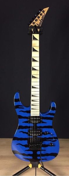 a blue and black guitar sitting on top of a table