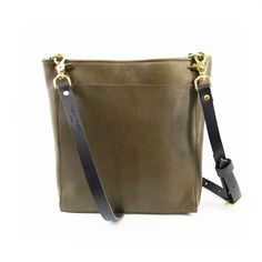 Olive Green Needless to say, this bag has earned its name. The classic crossbody bag, perfect for carrying every day. Available in lots of fun colors, to keep those days interesting. Pairs perfectly with our additional bag straps, because classic should never mean boring.Features: Full grain leather bag with crossbody strap Large front pocket Compartmentalized inside pocket Magnetic closure Solid brass hardware Dimensions: 13in wide, 10.5in tall, 3in deep 8 x 6 interior compartmentalized pocket Full Grain Leather Bag, Classic Crossbody Bag, Those Days, Brass Hardware, Bag Straps, Crossbody Strap, Full Grain Leather, Magnetic Closure, One Pic