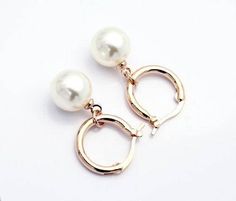 Elegant yet fun! Moon Drop pearl bead earrings add a touch of whimsy to plain pearl or even hoop earrings. A single pearl bead hangs from the rounded hoop with a hinged clasp closure. Dangling at 1.25 inches allows for graceful movement. Perfect for everyday wear or an affordable alternative to luxury pearls! Material: 18K Rose or White Gold plating Size: Hoop: 1.5cm Bead: 10mm Comes in a gift box. For Pierced Ears (Reg $35.95) Pearl Bead Earrings, Bead Hoop Earrings, Black Pearl Earrings, Rose Gold Hoop Earrings, Purple Pearl, Beaded Hoop Earrings, Beaded Hoops, Rose Earrings, Rose Gold Earrings