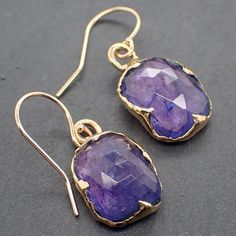 Introducing a beautiful and unique pair of Blue Tanzanite Dangle Earrings, handcrafted by the talented artisan Angeline using the traditional lost wax process. These stunning earrings are the perfect way to add a touch of elegance and sophistication to any outfit. Each earring features a breathtaking 12.5mm x 9.5mm blue Tanzanite gemstone, selected for its stunning color and quality. The Tanzanite is suspended from a delicate 14K gold wire, creating a graceful dangle style that will add a touch Elegant Tanzanite Formal Earrings, Elegant Tanzanite Earrings For Formal Occasions, Elegant 14k Gold Earrings With Gemstones, Elegant 14k Gold Gemstone Earrings, Exquisite 14k Gold Gemstone Earrings, Handmade Long Drop Elegant Earrings, Luxury Faceted Drop Earrings, Handmade Elegant Long Drop Earrings, Formal Tanzanite Teardrop Earrings