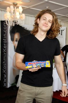 a young man holding a box of candy