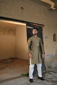 A unique dhani-colored silk kurta and plain cotton silk pajama with gold embroidery and motifs on the placket. Model wears Small/Medium. Traditional Slub Silk Kurta With Dabka Work, Diwali Slub Silk Kurta With Dabka Work, Traditional Drape Kurta With Dabka Work In Cotton Silk, Slub Silk Kurta With Gota Work For Eid, Cotton Silk Kurta With Dabka Work In Traditional Drape, Tussar Silk Kurta With Resham Embroidery For Eid, Eid Tussar Silk Kurta With Resham Embroidery, Navratri Chanderi Sherwani With Straight Kurta, Long Sleeve Raw Silk Kurta With Gota Work