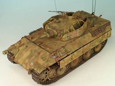 a toy army tank on a white surface