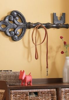 a horse bridle hangs on the wall next to a vase with flowers