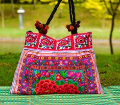 "Floral Tote Bag, Embroidered Shoulder Bag, Thai Bag This beautiful multi colored shoulder tote hand bag is made from embroidered Hmong fabric in stunning colors. The Hmong are a hill tribe people who live in the north of Thailand - also known as the Lanna region. The bag has a zipper closure at the top and is tapered from the top to the bottom - which adds a nice shape to the bag. Inside the bag is lined with a black strong cotton fabric. The is a zipper pocket on the inside for keys, coins etc Hippie Tote Bag, Hippie Backpack, Flowers Tote Bag, Embroidered Shoulder Bag, Beautiful Backpacks, Funky Hats, Boho Tote Bag, Shoulder Bag Pink, Flowers Tote