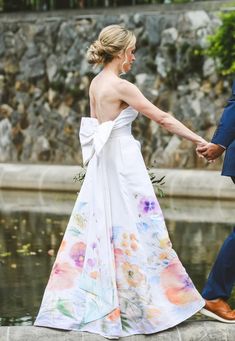 the bride and groom are holding hands