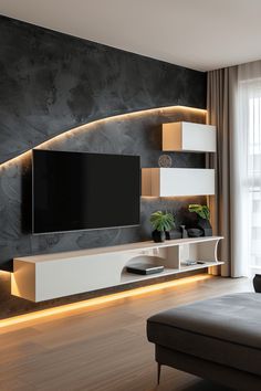 a modern living room with black and white walls, wood flooring and entertainment center