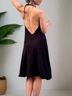 Simple black flowing dress. If we were to transform our favorite pair of black glorkapants into the dress - this would be it! Simple stretchy black dress that fits most sizes, and has two adjustable straps (you can tighten them up behind the neck and pull them lower if you want a deeper opening, or higher if you want more of the sporty look). This dress is a perfect everyday wear, as well as a cute going-out outfit. We danced in it, we meditated, did sun salutations and sat for a sound bath. We played with the belt, wrapping it around in different ways each time creating a different look! We love it! Try it out and play with it! Material: Cotton jersey (90% cotton 10 lycra). Very smooth and breathable. The dress is being handmade in two of our studios in New York and Los Angeles. Size: One Black Dress With Spaghetti Straps And Built-in Bra, Black Spaghetti Strap Dress With Built-in Bra, Chic Black Halter Dress With Back Opening, Black Stretch Dress With Built-in Bra, Black Halter Neck Suspender Dress For Evening, Black Stretch Backless Dress With Spaghetti Straps, Black Backless Dress With Built-in Bra, Black Stretch Suspender Dress For Night Out, Stretch Black Halter Dress For Night Out