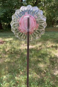 a glass sun catcher sitting on top of a grass covered field