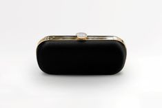 The Black Bella Clutch is a duchess satin designer bridal and evening clutch, perfect for a divine, fancy black-tie occasion on your calendar! The Black Bella Clutch makes a statement! Designed with a contemporary vision, the Black Bella Clutch is made of duchess satin and crafted by the finest Italian artisans. The perfect accessory to complete a refined and glamorous black-tie outfit, The Black Bella Clutch will become a staple in your wardrobe. Paired best with silver hardware! The Bella Clut Luxury Satin Evening Bag For Events, Luxury Satin Bags For Formal Occasions, Elegant Rectangular Satin Evening Bag, Elegant Satin Rectangular Evening Bag, Classic Clutch Evening Bag For Wedding, Elegant Evening Bag For Party, Chic Satin Evening Bag For Formal Occasions, Elegant Satin Rectangular Bag, Elegant Rectangular Satin Bag