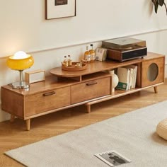 a living room with a couch, coffee table and bookshelf on the floor