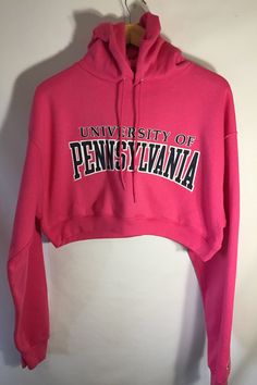 University of Pennsylvania Cropped Hoodie Spring Hoodie With Letter Print And Stretch Fit, Spring Stretch Hoodie With Letter Print, Fitted Letter Print Sweatshirt For Spring, Fitted Crew Neck Hoodie For Spring, Fall Varsity Sweatshirt With Adjustable Hood, Varsity Sweatshirt With Adjustable Hood For Fall, Spring Fitted Hoodie With Letter Print, Pink Hooded Sweatshirt For Sports Season, Spring Fleece Stretch Hoodie