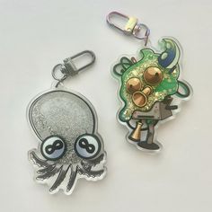 two key chains with cartoon characters on them