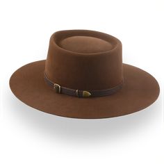 Description Materials Craftsmanship Hat Care Shipping Returns Product Description A Clint Eastwood Inspired Cowboy Hat Step into the rugged charm of the Old West with The Drifter, a cowboy hat that channels Clint Eastwood's legendary style. This handcrafted masterpiece is made from durable, premium rabbit fur felt, designed to endure adventures while exuding effortless sophistication. Featuring a classic telescope crown paired with a bold 4 1/2" height and a 3 5/8" raw-edged flat brim, this hat strikes the perfect balance between vintage authenticity and modern craftsmanship. A genuine leather hat belt accents the design, adding a touch of Western heritage to its timeless appeal. Tailored to your precise head size, The Drifter ensures unparalleled comfort and a flawless fit. Whether you’re Indiana Jones Fedora, Mens Felt Hats, Spanish Hat, Brown Cowboy Hat, Adventure Hat, Trilby Hat, Leather Hat, Classic Hats, The Old West