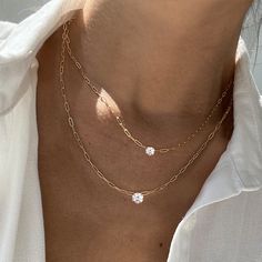 A twist on a classic, our Charo necklace features a choice of two different sized round diamonds secured in a 4 prong setting. A classic piece you will cherish for a lifetime. This necklace can be dressed up or down, layered with our Herringbone Chain Necklace , or worn by itself. – Made in 18k solid gold with a high-quality ethically sourced diamond. – Handpicked G-H/SI Round Brilliant Diamond, carat weight 0.50 – Choice of adjustable chain length, 16 and 18 inches. – Handcrafted just for you i Formal Double Strand Diamond Necklace, Timeless Solitaire Necklace With Clavicle Chain, Timeless Solitaire Necklace With Clavicle Chain As A Gift, Timeless Solitaire Necklace With Clavicle Chain For Formal Occasions, Timeless Solitaire Necklace For Gift, Timeless Formal Solitaire Necklace With Clavicle Chain, Elegant Double Strand Diamond Necklaces, Elegant Double Strand Diamond Necklace, Delicate Cubic Zirconia Necklace With Prong Setting