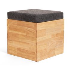 a wooden box with a black cushion on top