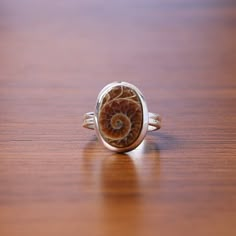 Ammonite Ring, 925 Sterling Silver Ring, Oval Gemstone Ring, Handmade Jewelry, Fossil Ring, Vintage Ring, Boho Ring, Birthday Gift for Her Gemstone Name - Ammonite  Stone Quality - AAA Ring Weight - 4.03 gm Ring Length - 1.5 cm Ringh Width - 1.2 cm Stone Shape - As shown in the picture * You Will Get The Same Product As Shown In The Picture. We serve complete 925 sterling silver Jewelry and genuine properties of the stone. The products are dispatched from the small business from USA. Product Qua Oval Sterling Silver Engraved Gemstone Ring, Unique Oval Engraved Ring With Gemstone, Untreated Oval Ring For Anniversary, Unique Engraved Oval Ring With Gemstone, Anniversary Rings With Natural Inclusions, Oval Cabochon Shape, Unique Sterling Silver Oval Ring, Unique Oval Sterling Silver Rings, Nickel-free Oval Sterling Silver Crystal Ring, Nickel-free Oval Crystal Ring In Sterling Silver