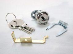 several different types of keys and locks on a white surface