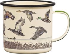 a ceramic mug with ducks on it