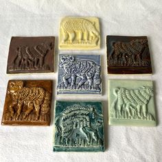 six different animal soaps sitting on top of a white sheet